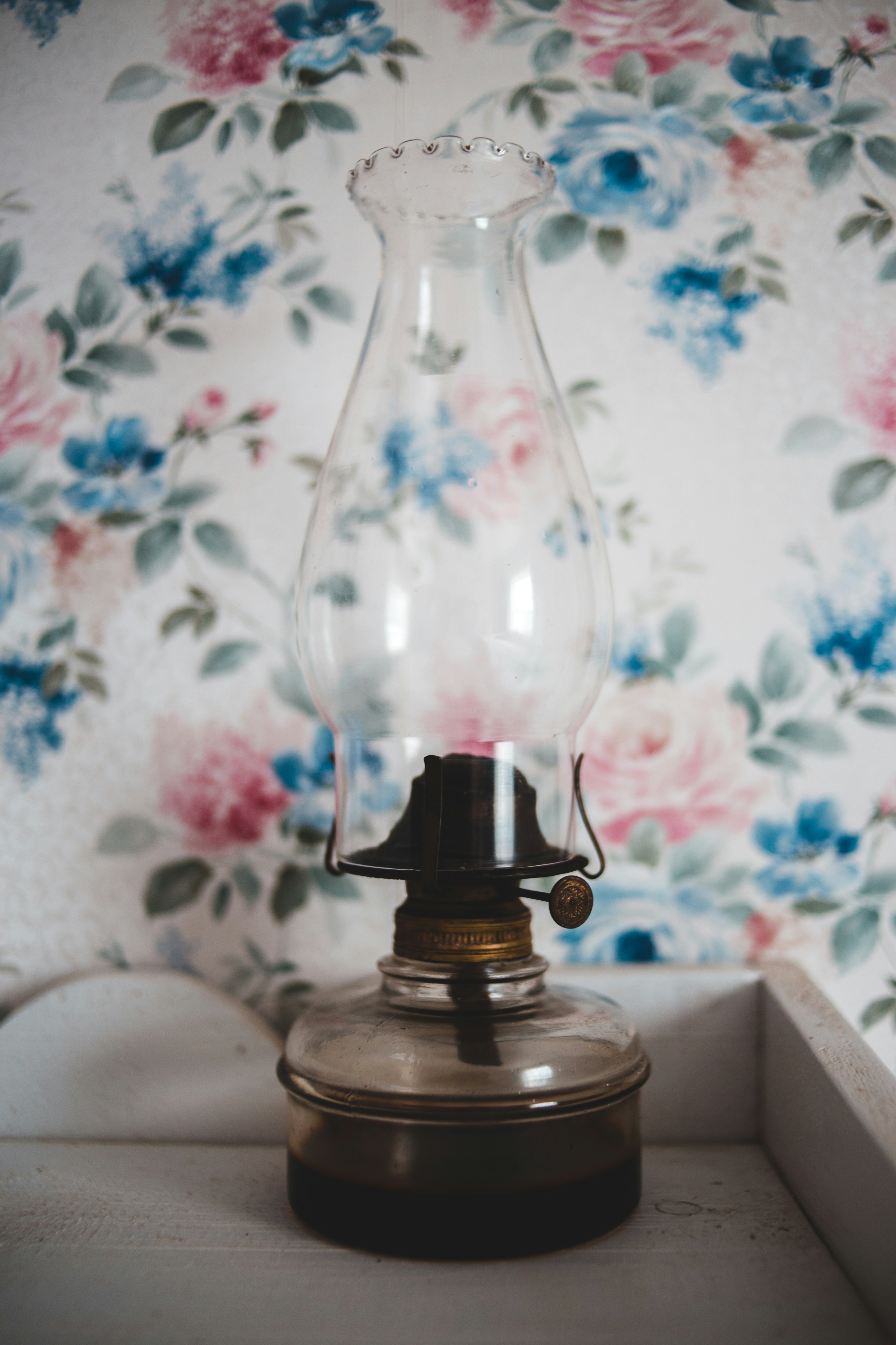 clear glass lamp on white wooden table